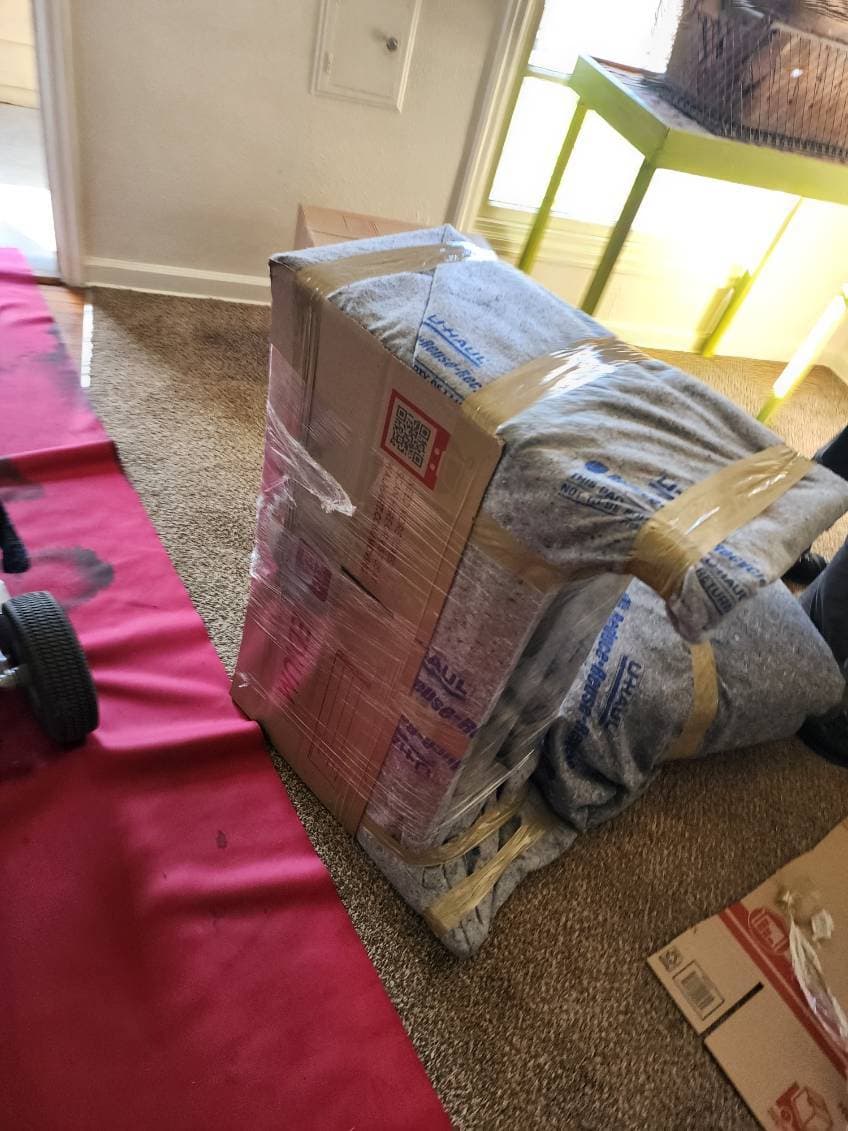 Wrapped dresser on a dolly over floor protection
