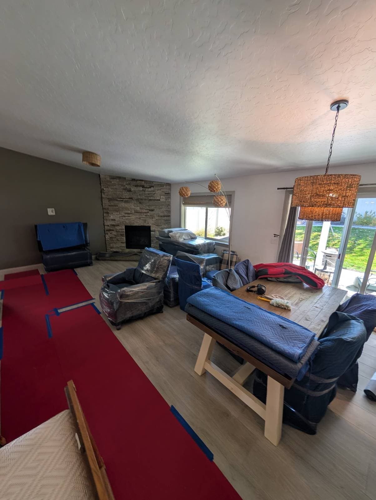 A living room of wrapped furniture staged on runners
