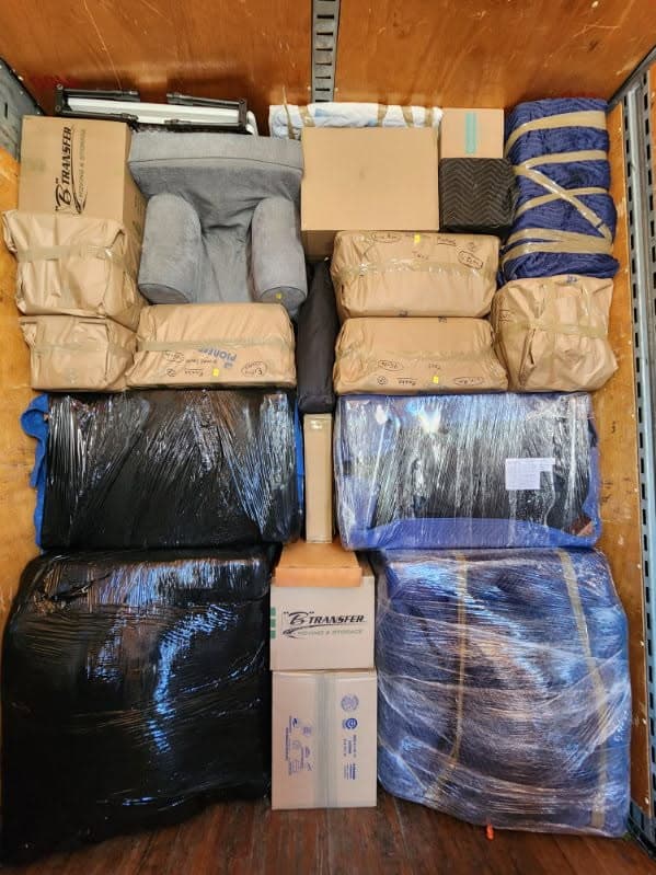 Paper-wrapped cushions and shrink-wrapped stacks in a container